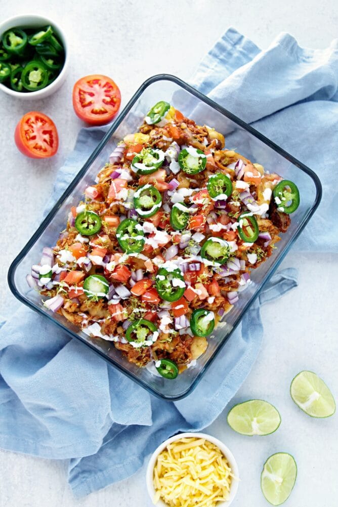 Overhead shot of finished bbq chicken totchos surrounded by toppings