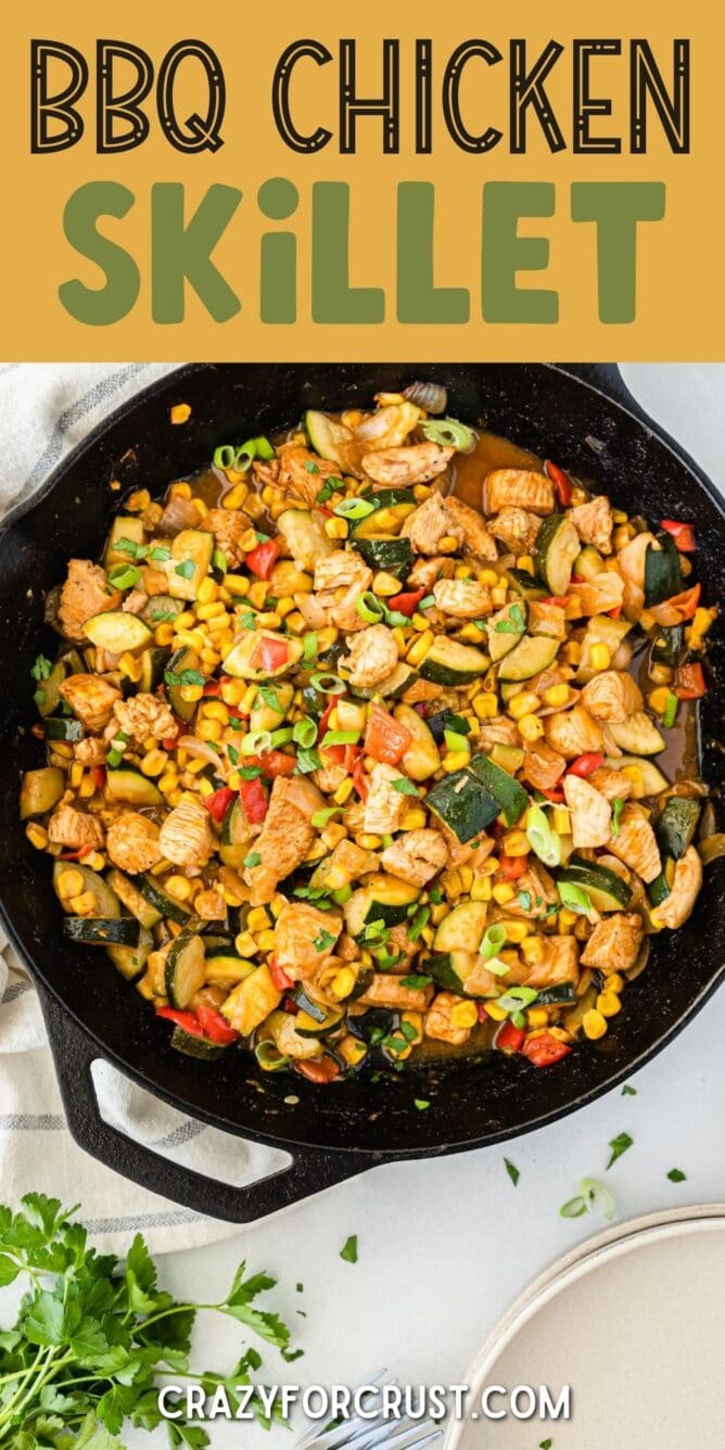 Overhead shot of bbq chicken skillet in cast iron with recipe title on top of image