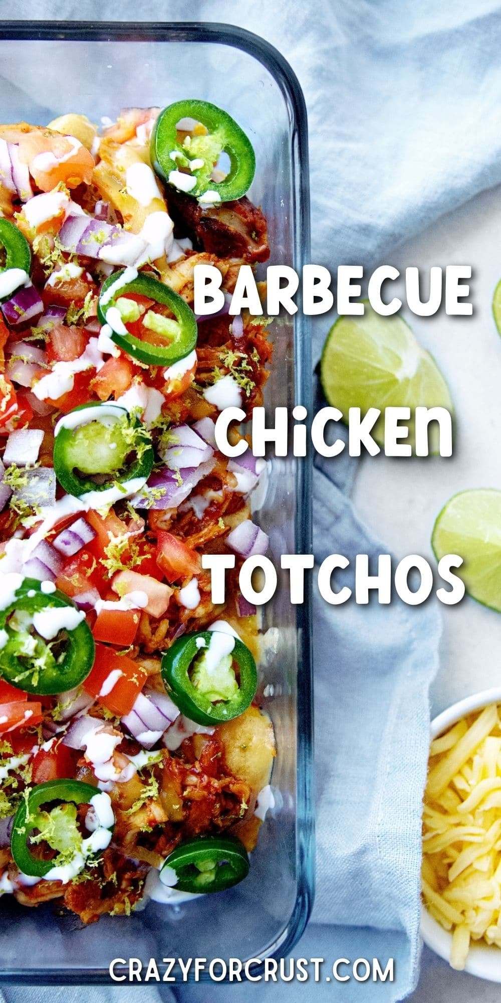 Close up overhead shot of bbq chicken totchos next to shredded cheese and lime wedges with recipe title in middle of photo