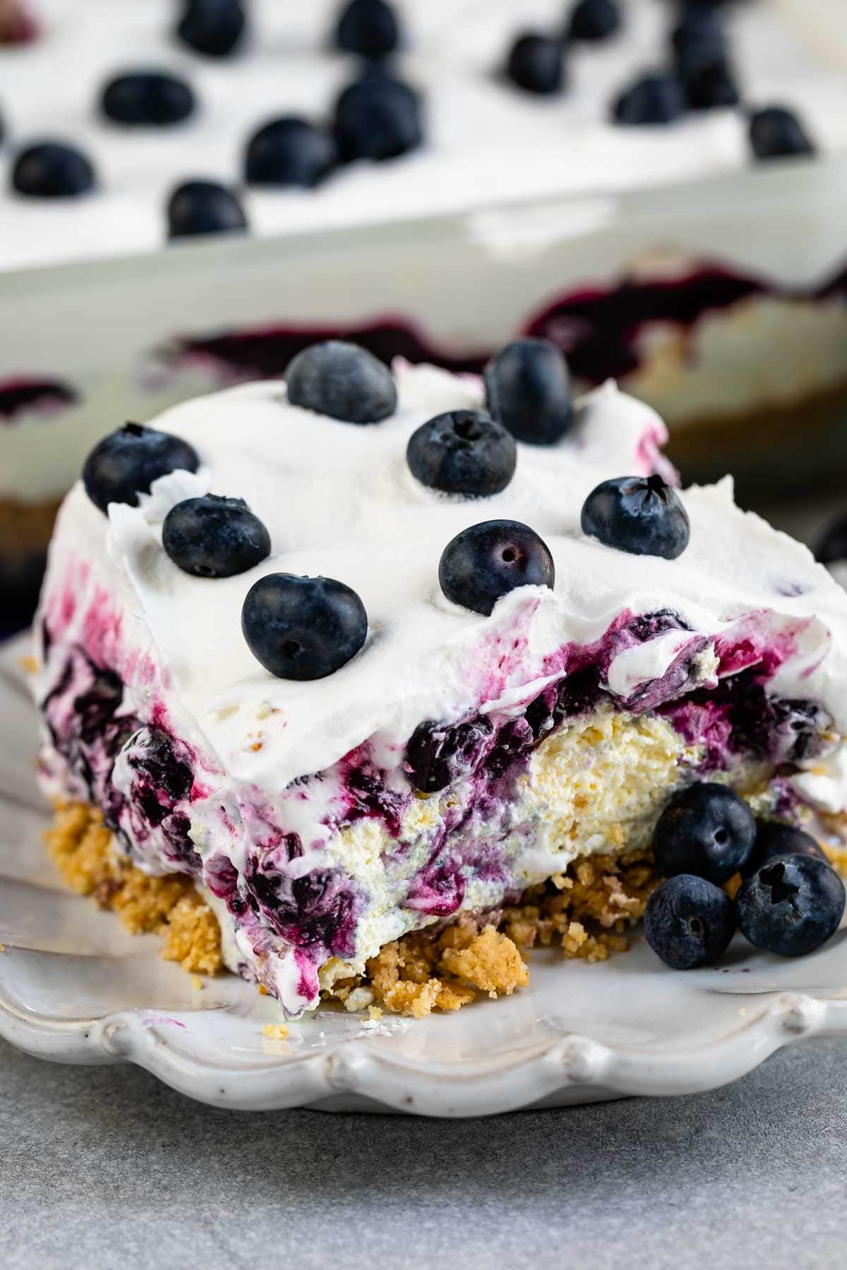 One large square slice of blueberry delight lush on a plate