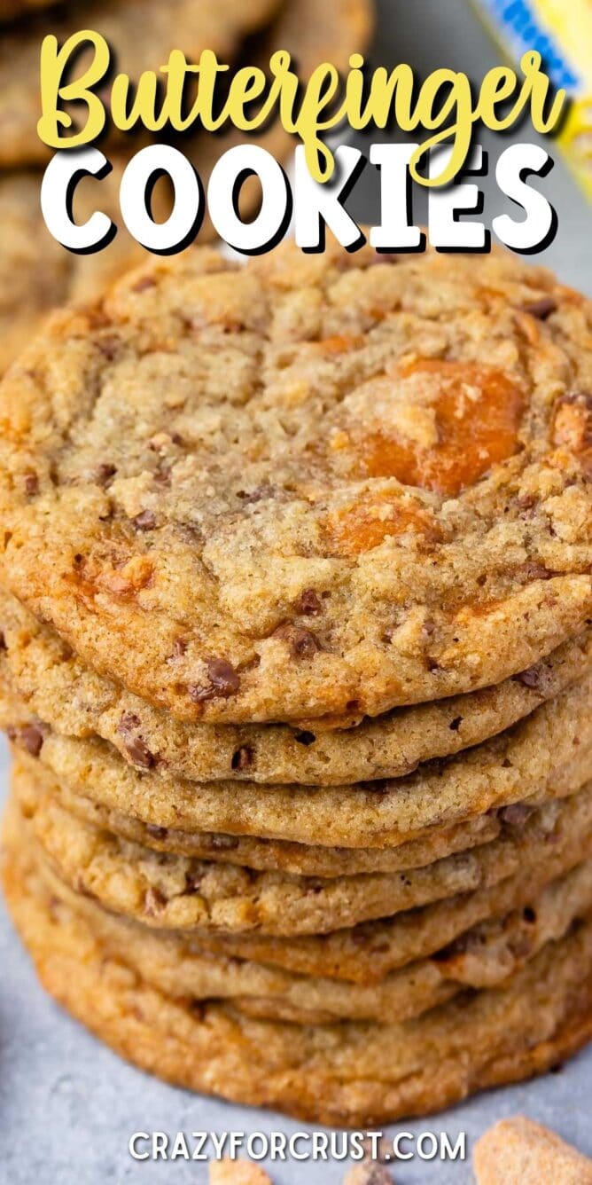 Overhead shot of a large stack of butterfinger cookies with recipe title on top of image
