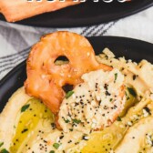 Pretzel chip being dipped into everything hummus with recipe title on top of image