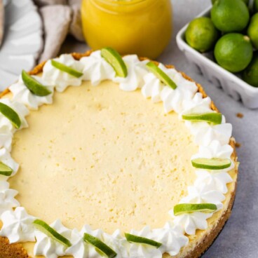 cheesecake with lime slices and whipped cream