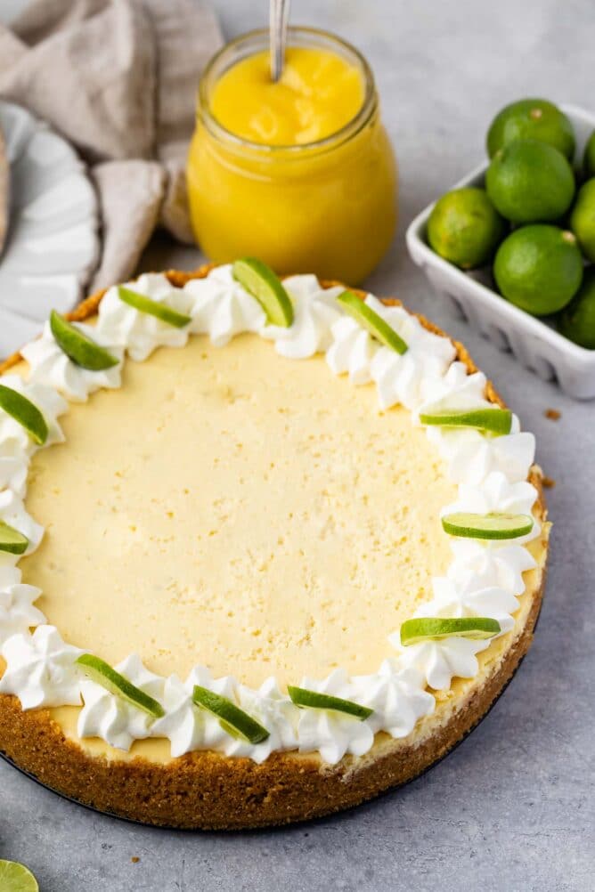 cheesecake with lime slices and whipped cream