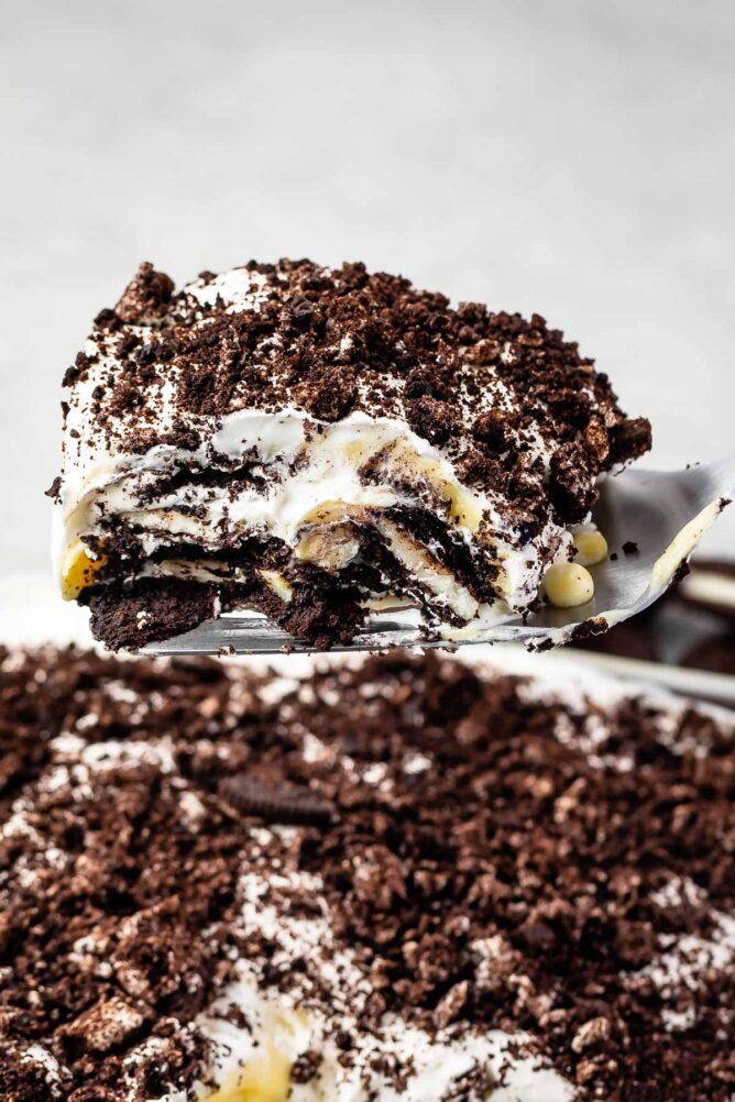 One big scoop of Oreo Lasagna being lifted out of the pan