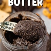 Small spoon scooping out oreo peanut butter from small mason jar with recipe title on top of image