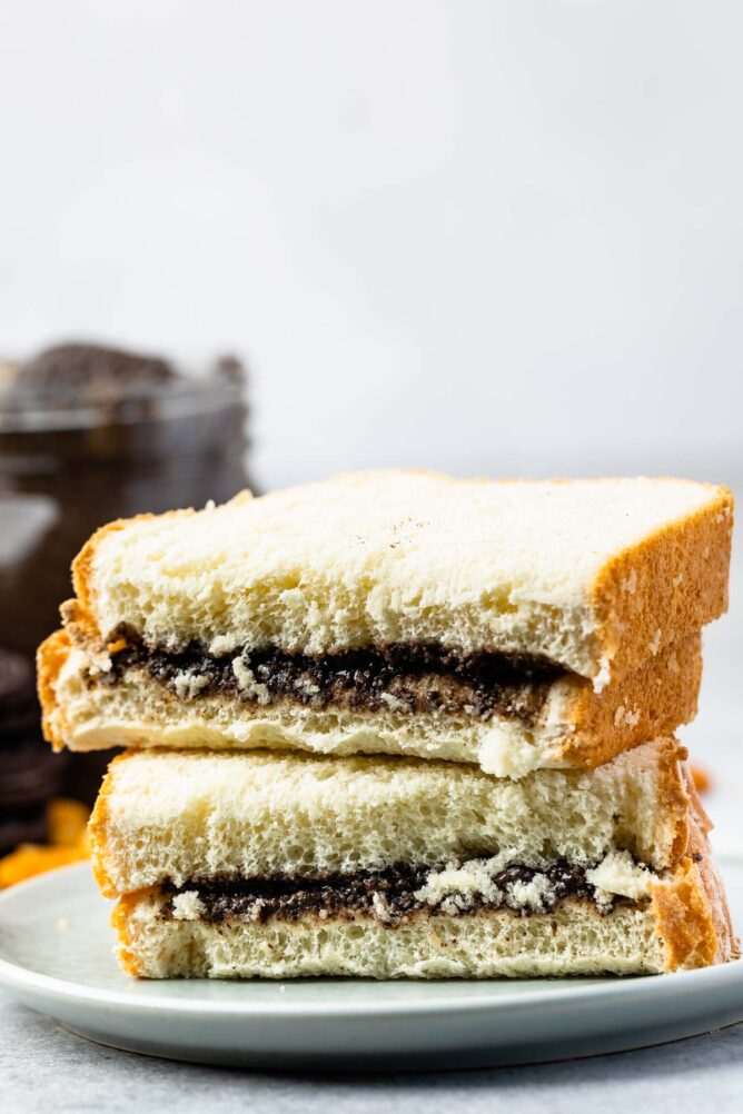 Oreo peanut butter sandwich cut in half on a small plate