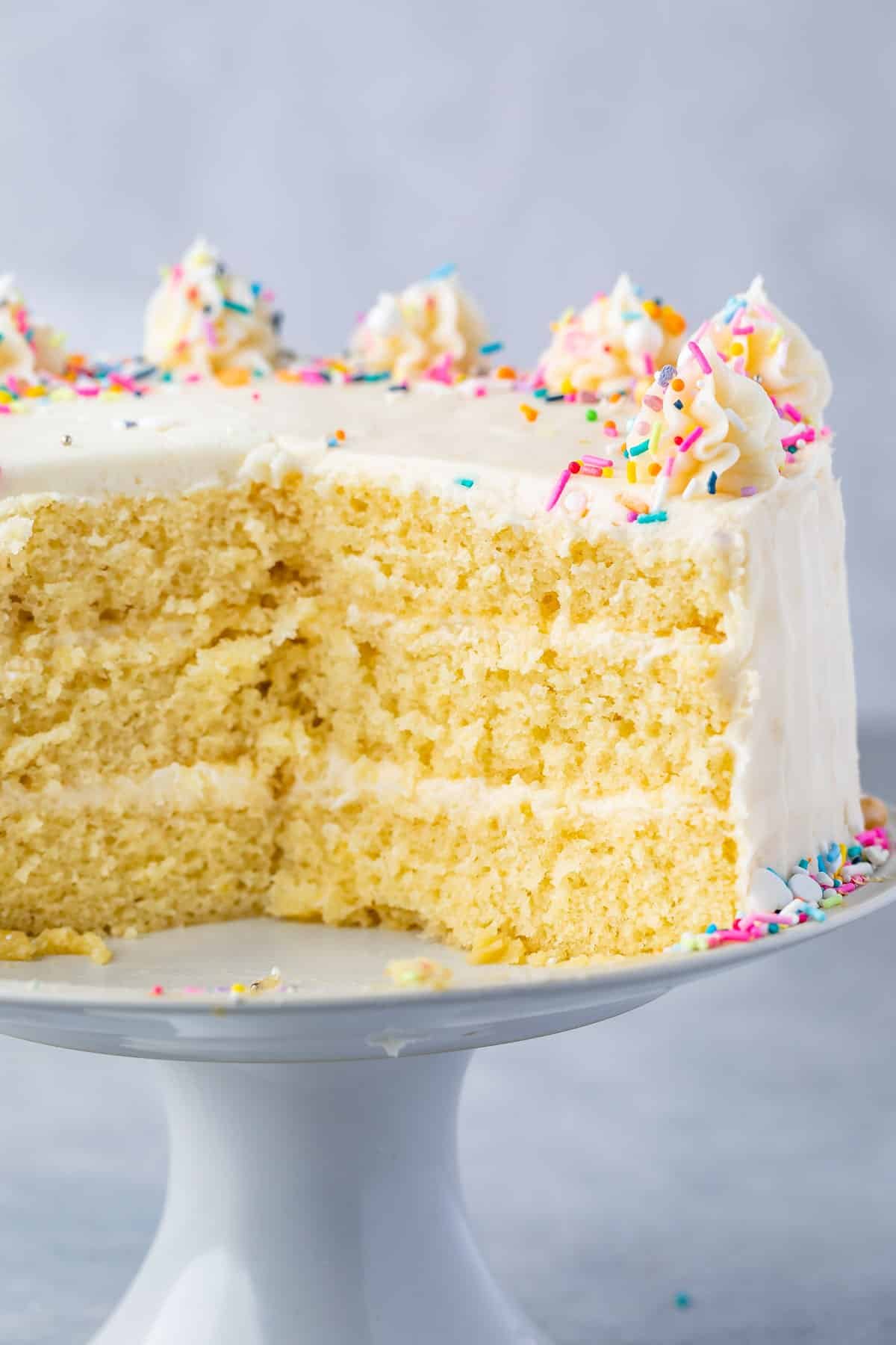 3 layer yellow cake cut open on cake plate.