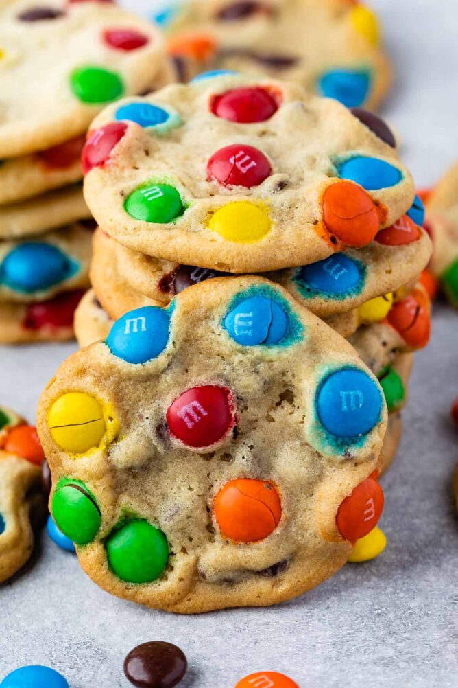 Stacks of M&M cookies on parchment paper