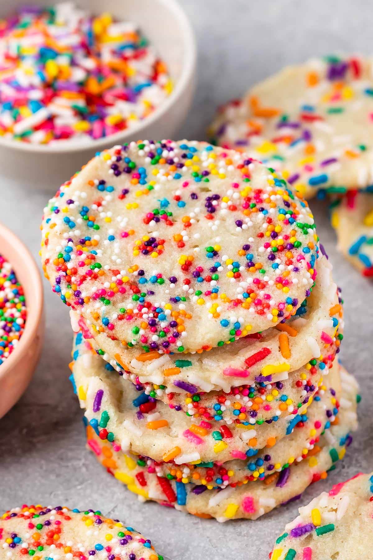 Four 2 ingredient sprinkle sugar cookies stacked on top of eachother