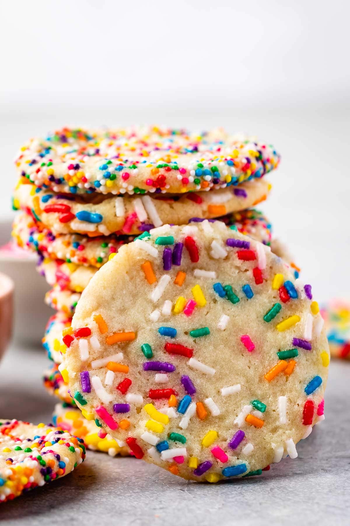 Stack of 2 ingredient sprinkle sugar cookies with one front facing the camera