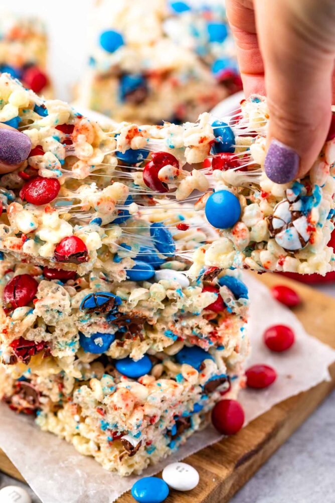 4th of July rice krispie treat being pulled apart to show ooey gooey marshmallow