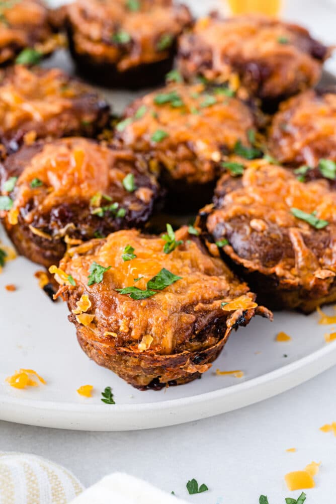 Mini BBQ meatloaves topped with cheese on a plate