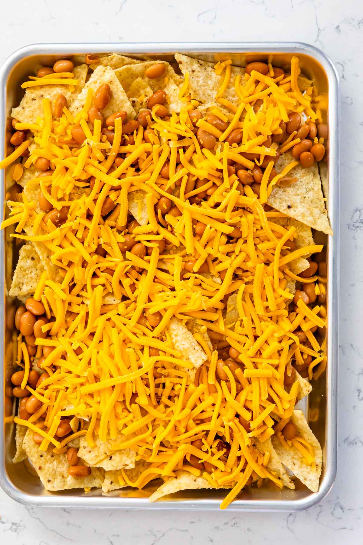 tray with chips and pinto beans and cheese.