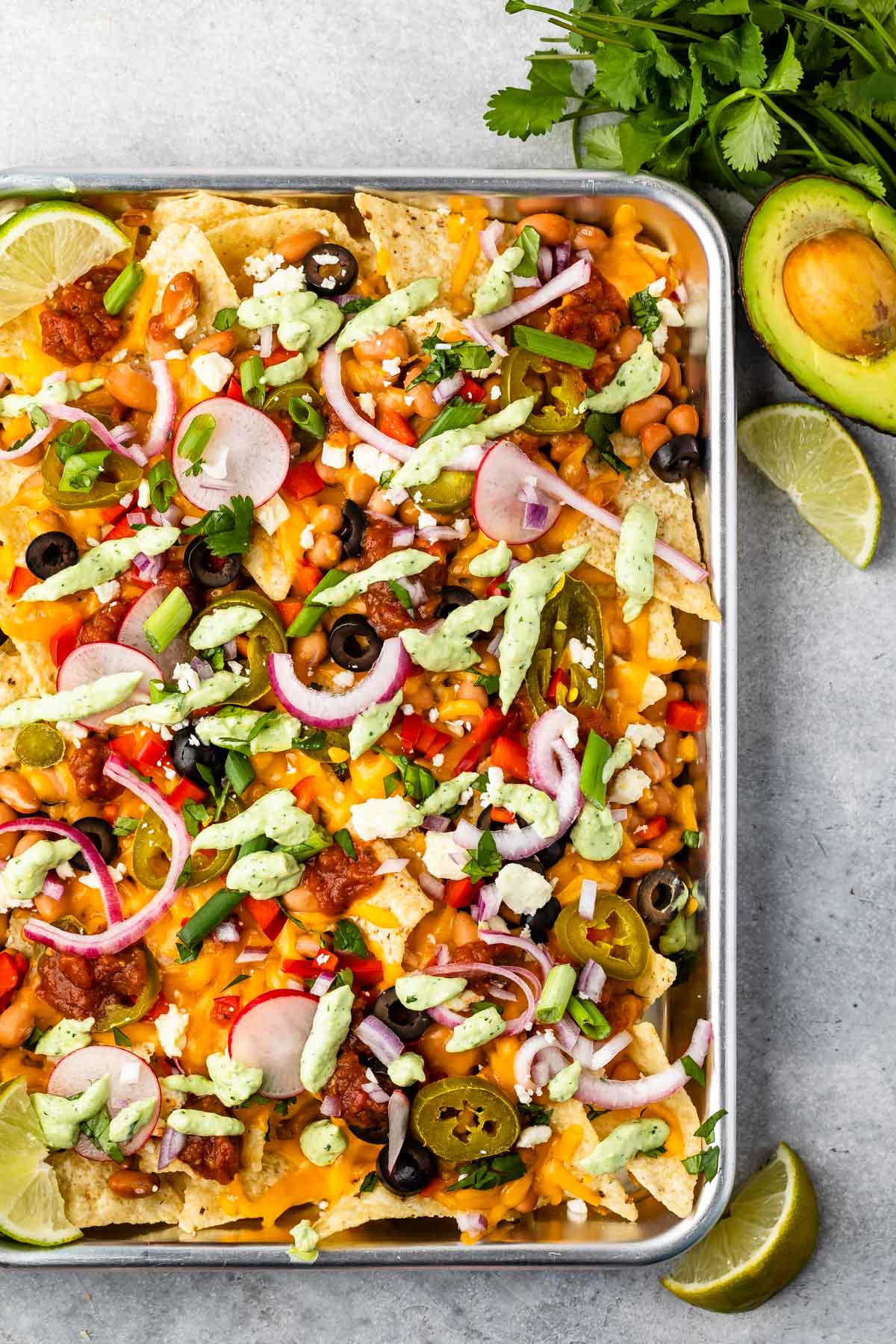 Veggie sheet pan nachos topped with all the fixings