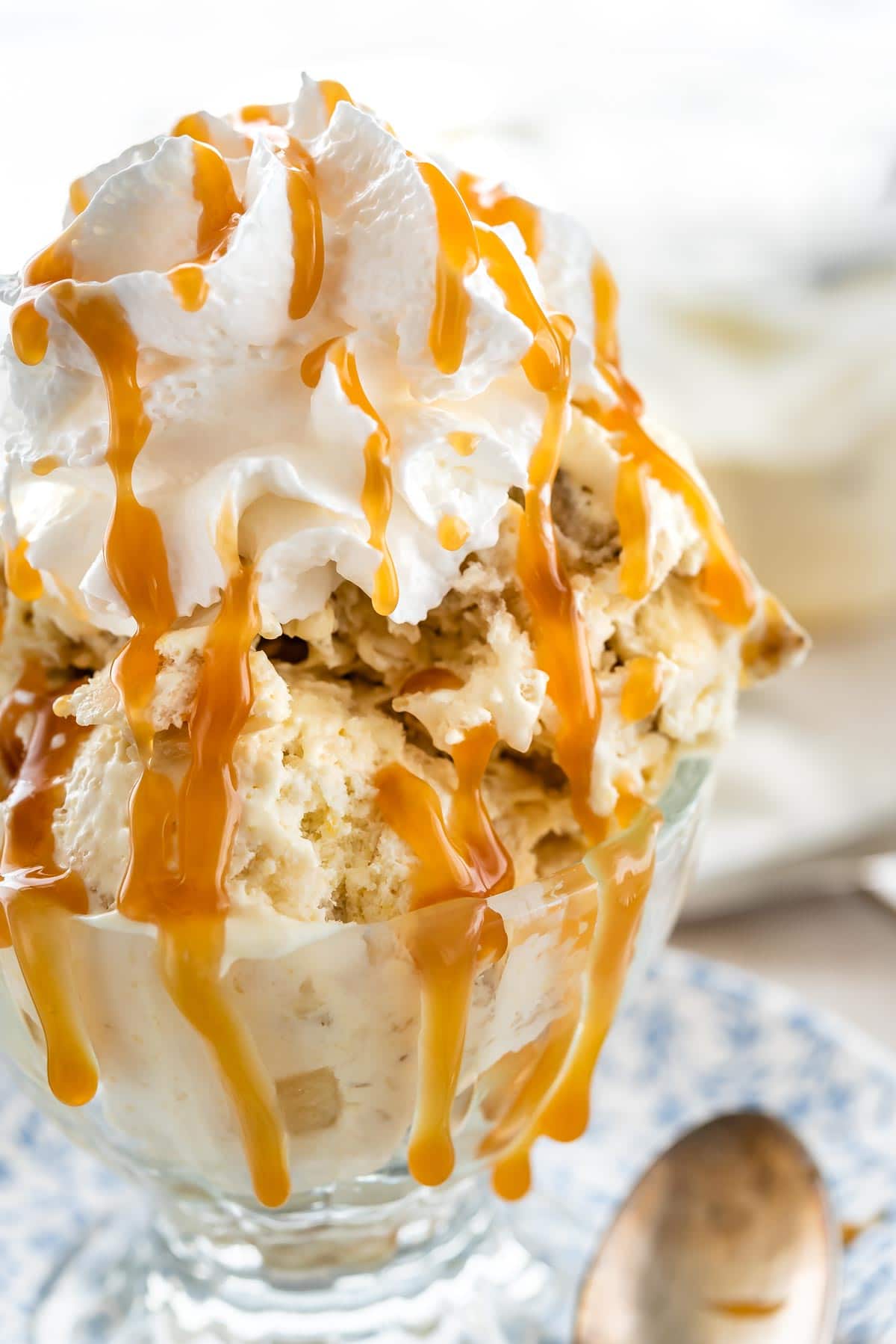 Banana cream pie ice cream topped with whipped cream and caramel sauce in a serving dish