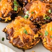 Mini BBQ meatloaves topped with cheese on a plate with recipe title on bottom of photo