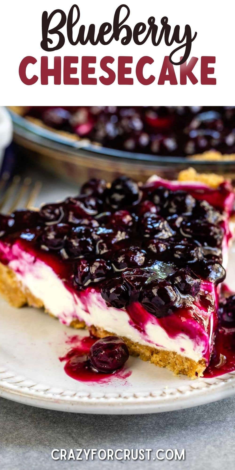 One slice of blueberry cream cheese pie on a plate with rest of pie behind it and recipe title on top of image