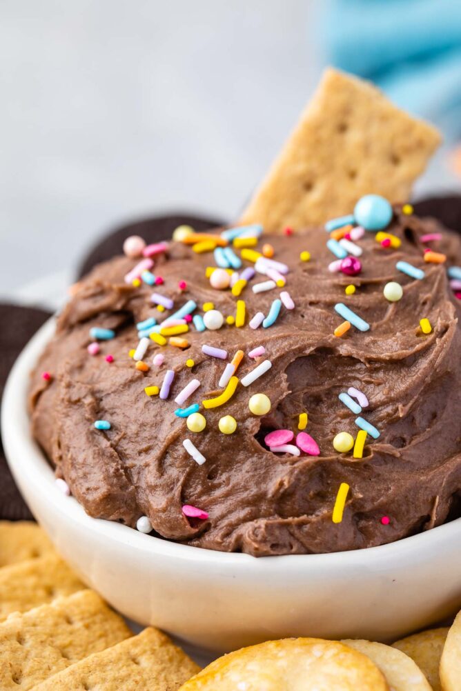 Close up shot of cake batter dip in a bowl topped with sprinkles