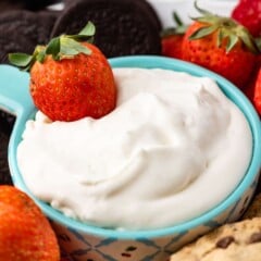 Close up shot of cheesecake dip with a strawberry in it