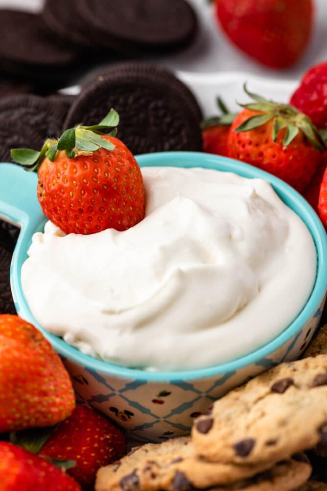 Close up shot of cheesecake dip with a strawberry in it