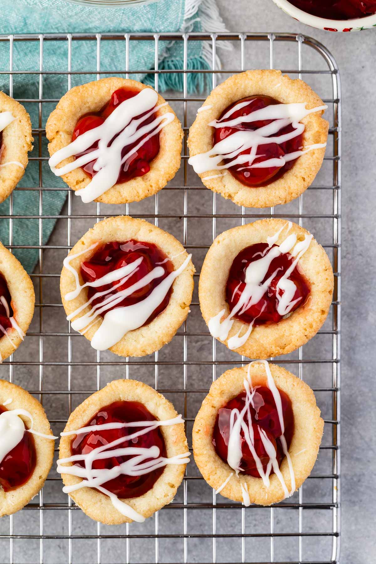 Overhead shot of cherry pie cups on a wire cooling rack