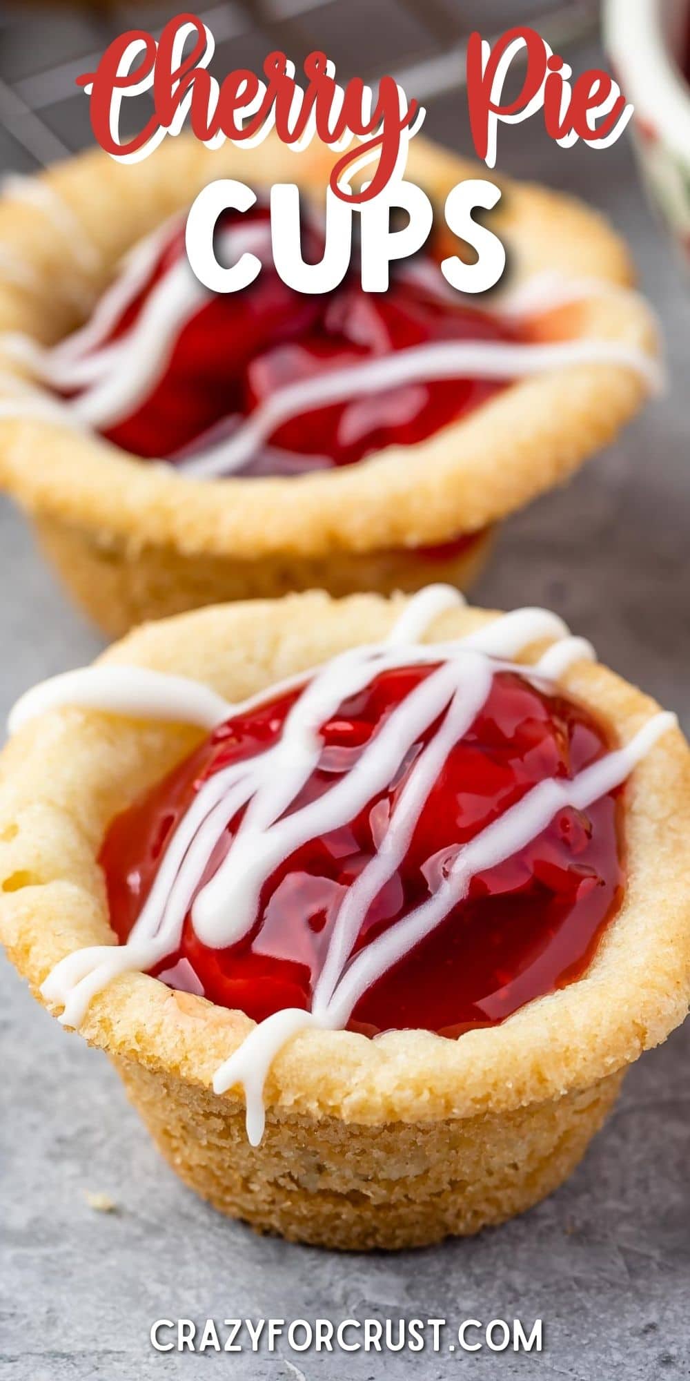 Close up shot of two cherry pie cups with recipe title on top of image