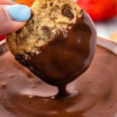 Chocolate chip cookie being dipped into chocolate dip with recipe title on top of photo