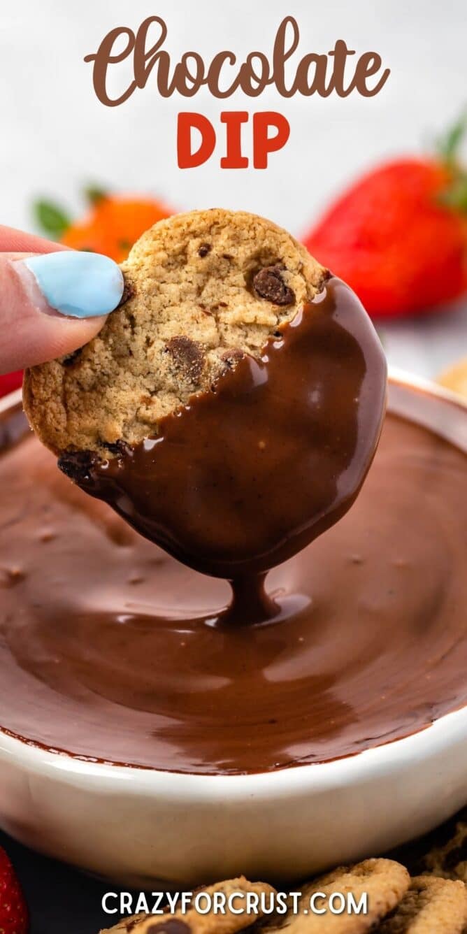 Chocolate chip cookie being dipped into chocolate dip with recipe title on top of photo