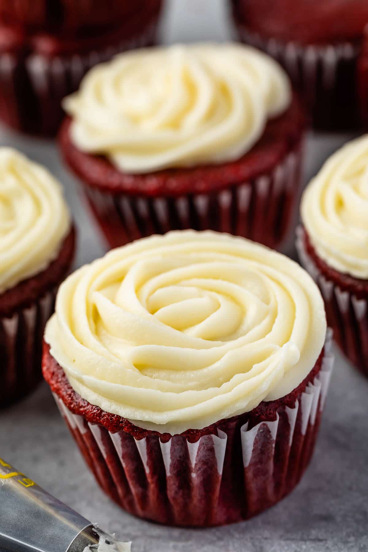 Red velvet cupcakes with cream cheese frosting on top