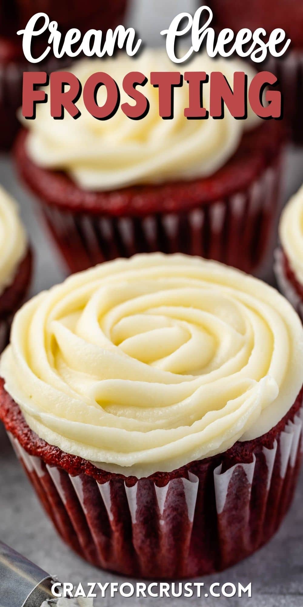 Red velvet cupcakes with cream cheese frosting and recipe title on top of image