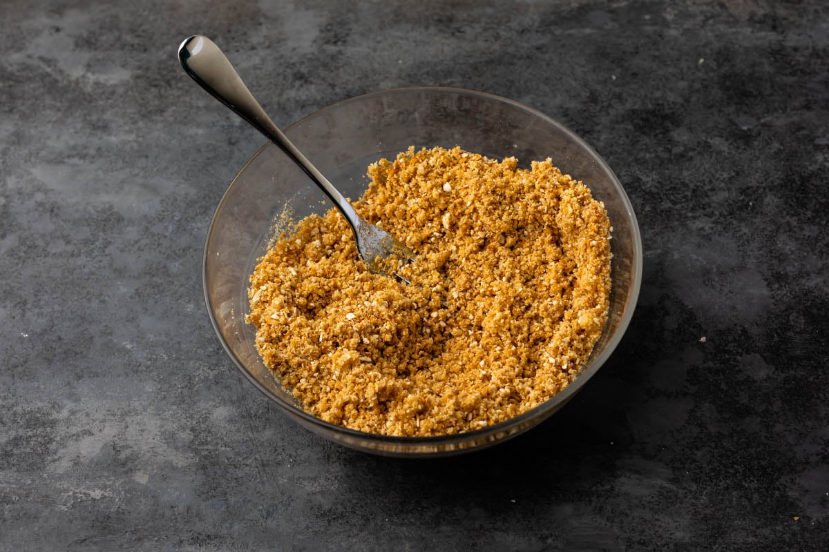 Combined pretzel crust mixture in glass mixing bowl