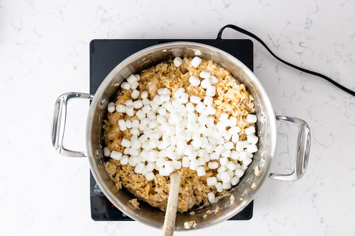 Rice Krispies and mini marshmallows in large pot on hot plate.