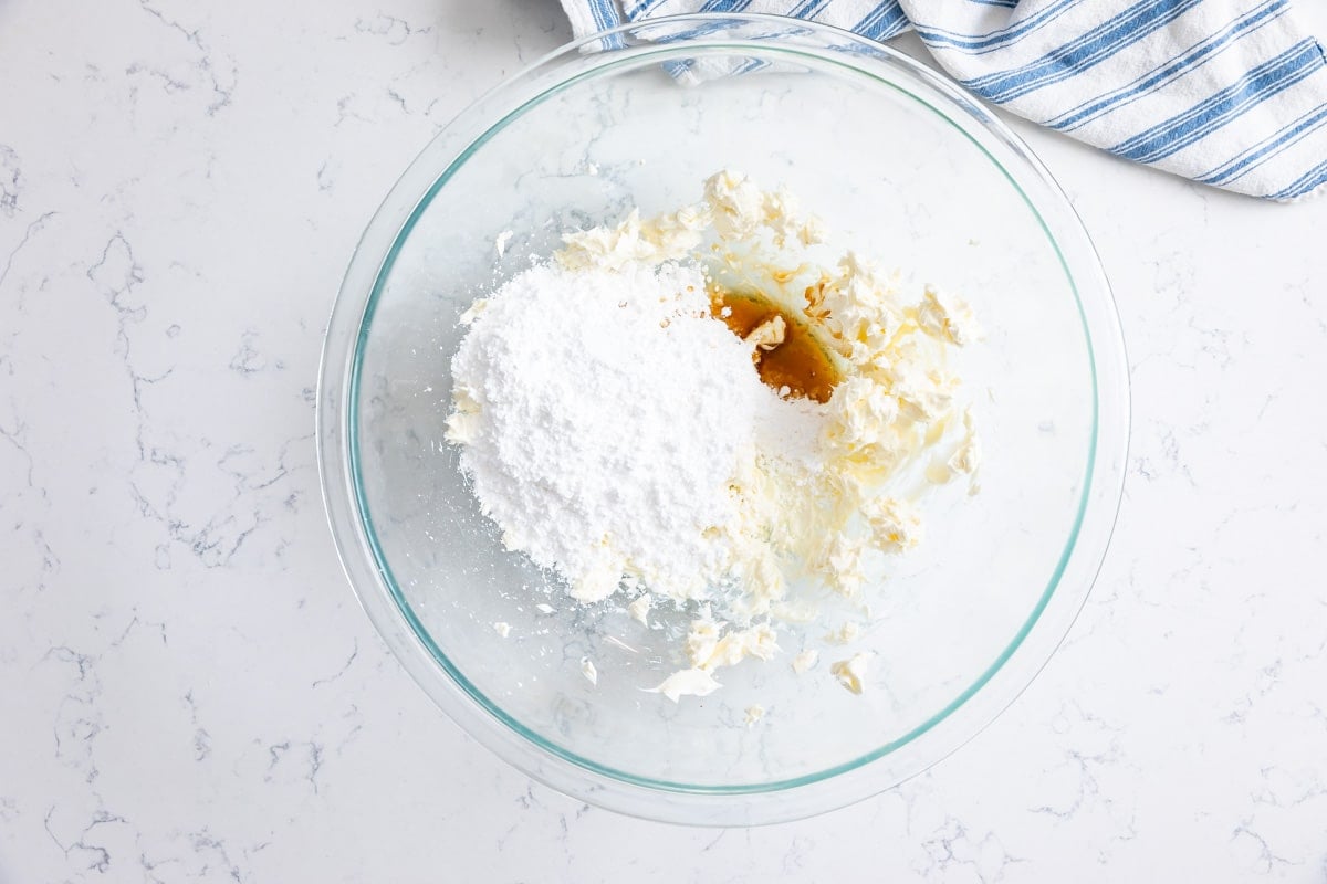 cream cheese with powdered sugar and vanilla in bowl.