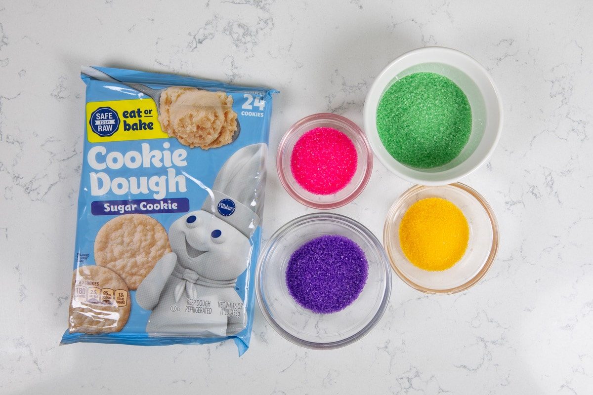 cookie dough package with bowls of colored sugar.