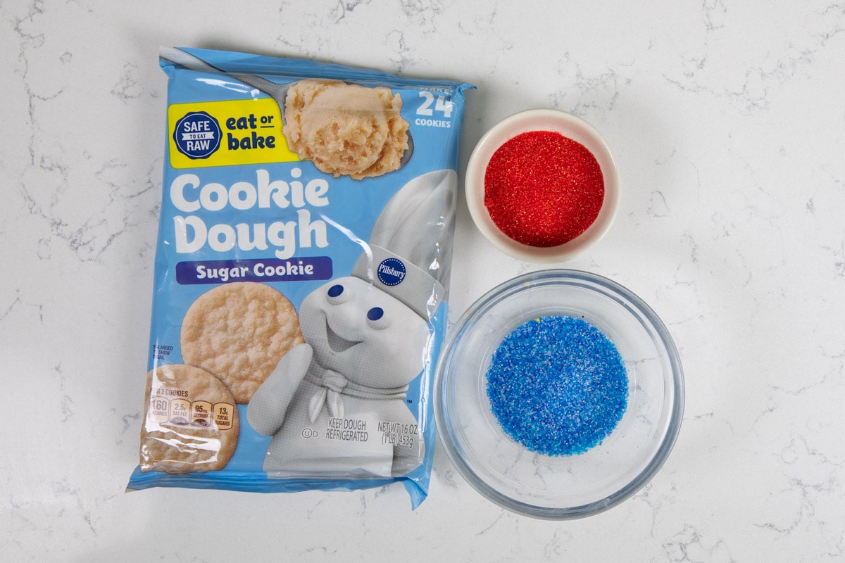 cookie dough package with bowls of colored sugar.