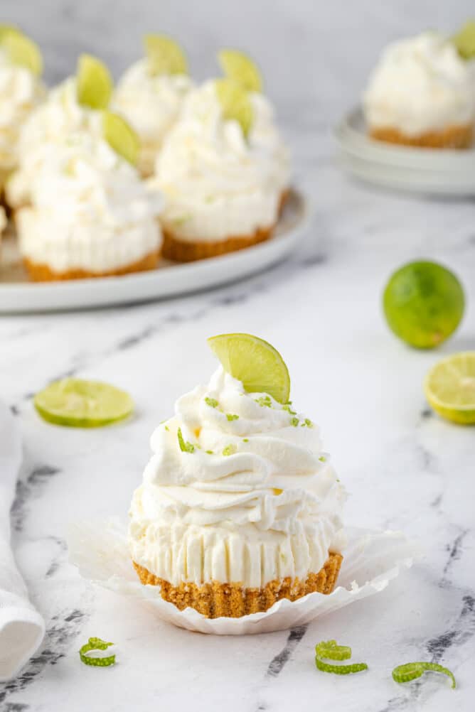 One mini no bake key lime cheesecake with more in the background