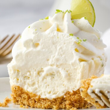 Close up of no bake key lime cheesecake cut in half to show inside