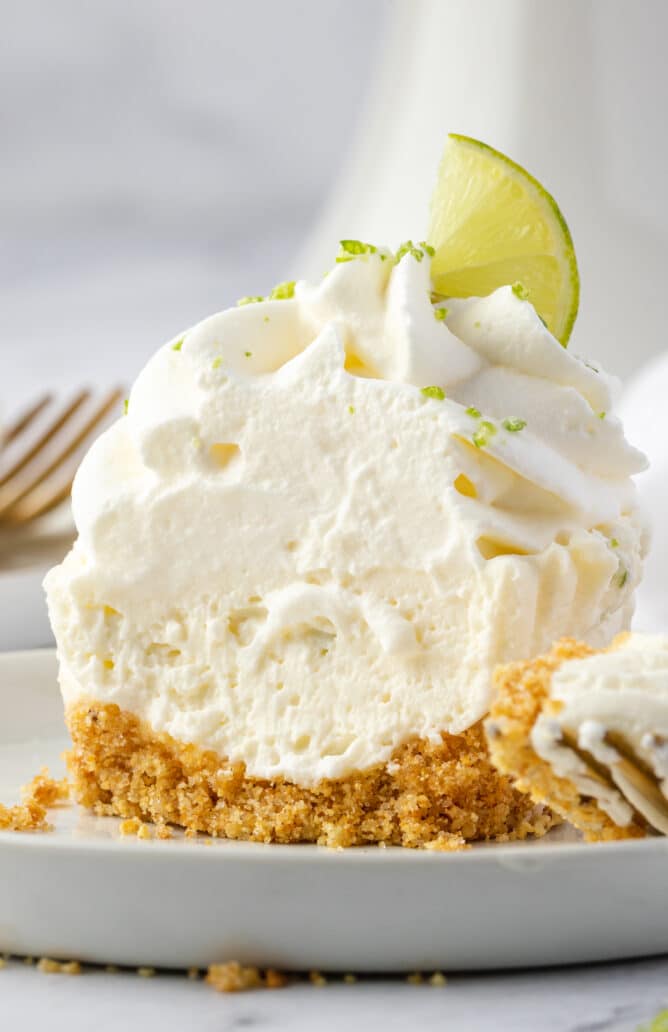 Close up of no bake key lime cheesecake cut in half to show inside