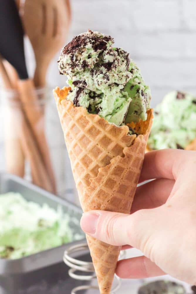 ice cream in cone being held by hand.