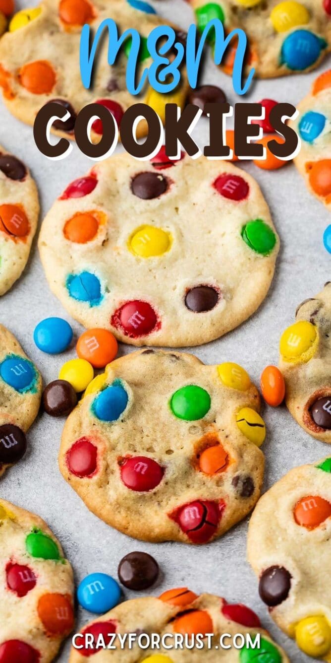 2 Ingredient M&m Cookies on parchment paper surrounded by more M&Ms with recipe title on top of image