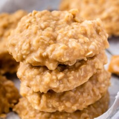 Four no bake peanut butter cookies stacked on top of eachother