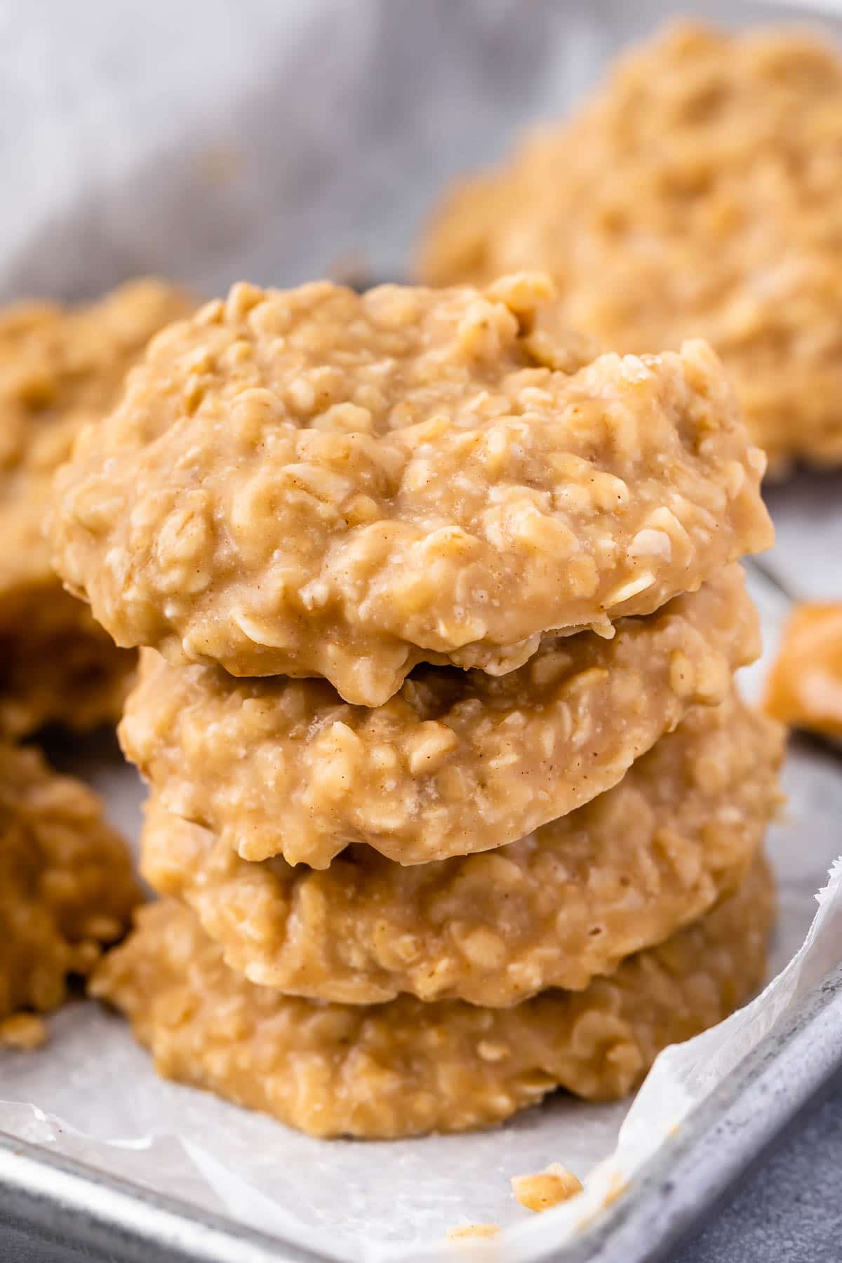 Four no bake peanut butter cookies stacked on top of eachother