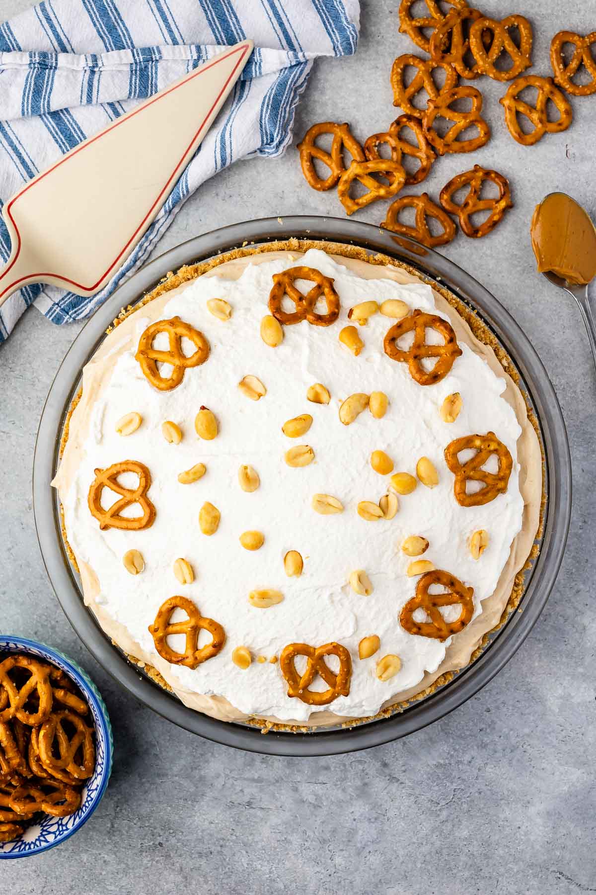 Overhead shot of pretzel peanut butter pie topped with pretzels and peanuts