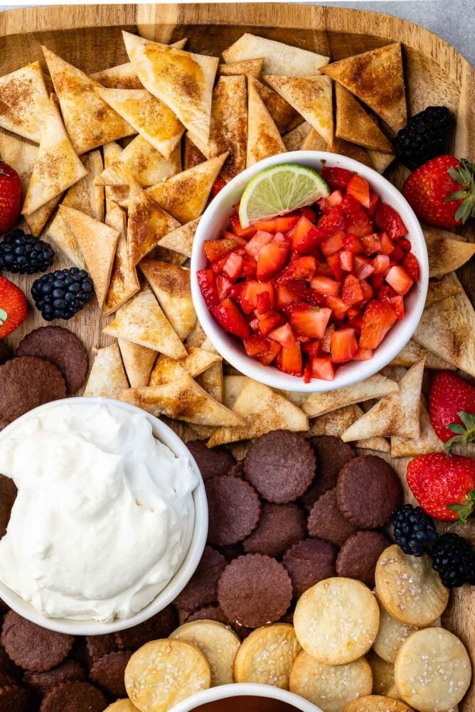 Overhead shot of sweet dip board filled with pie crust chips and dips