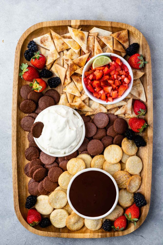 Overhead shot of sweet dip board filled with pie crust chips and dips