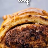 Chocolate cinnamon roll pull apart bread on parchment paper with recipe title on top of image