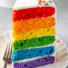 slice of rainbow cake on white plate