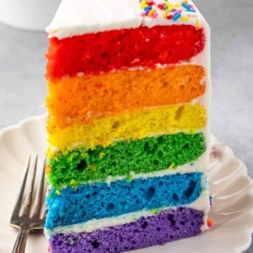slice of rainbow cake on white plate