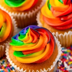 Overhead shot of rainbow swirl frosting on top of vanilla cupcakes